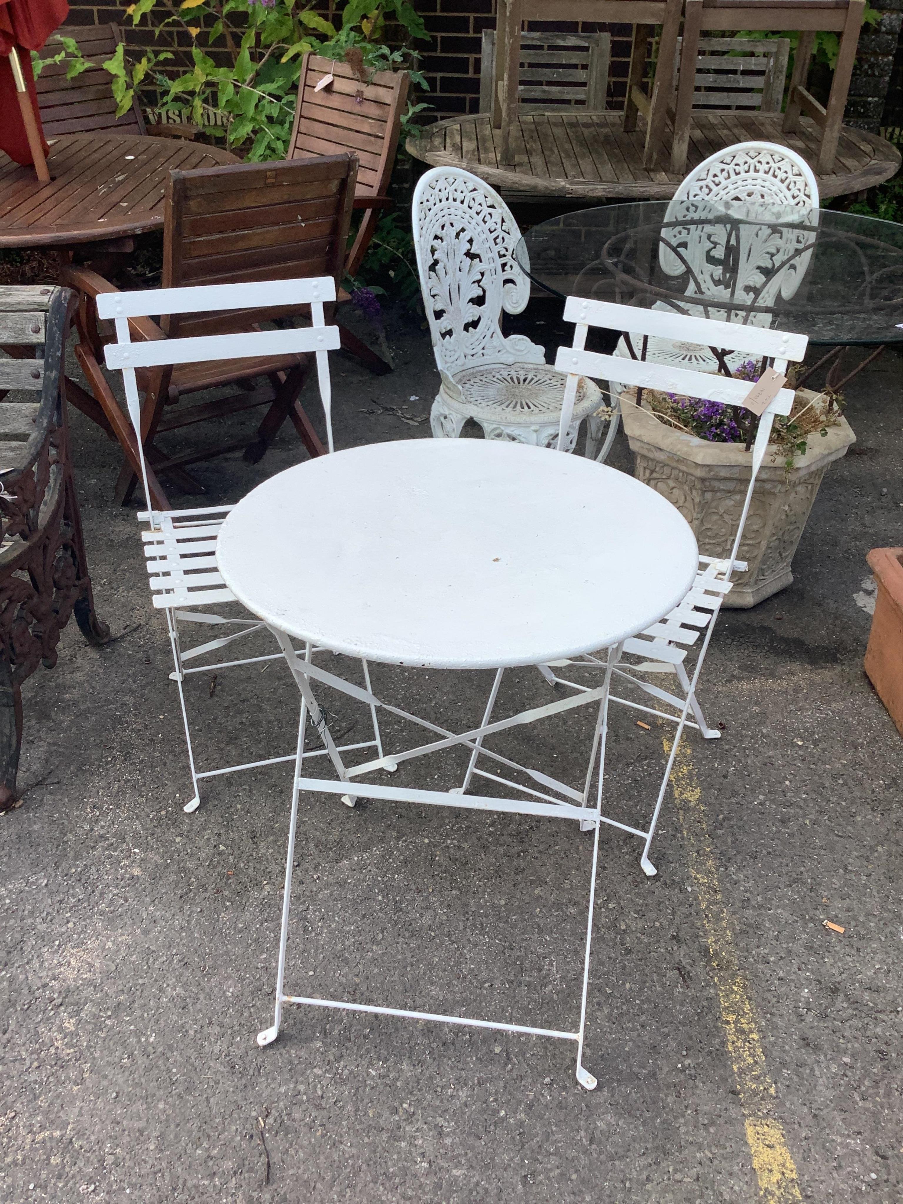 A circular painted metal folding garden table, diameter 59cm, height 71cm, together with a pair of folding chairs. Condition - good